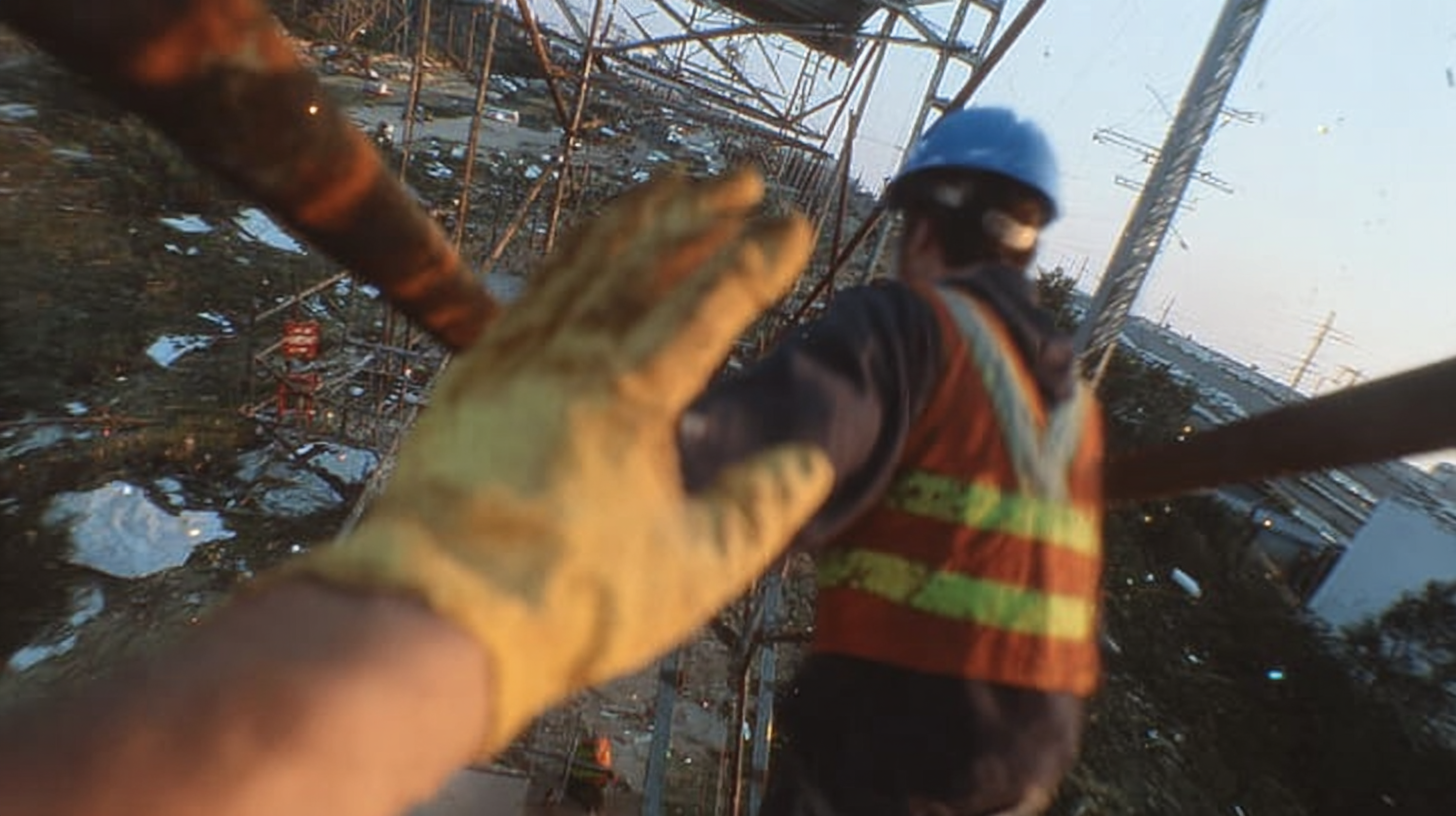 Professional field technician wearing Kenesis Vision smart glasses while working on industrial equipment